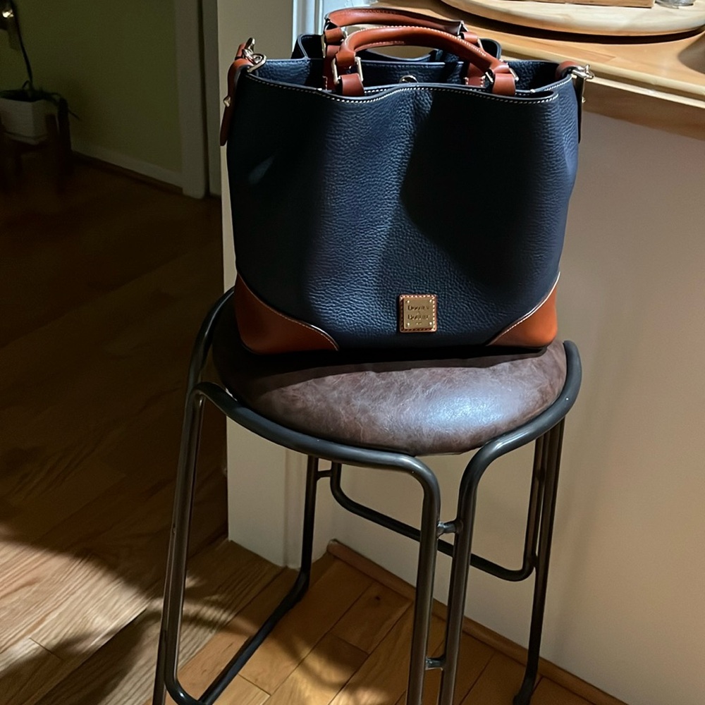 Dooney& Burke navy handbag. New. Never used. Leather handbag with key ring